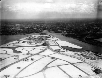 A 1927 aerial of the same Tampa Bay water now built into land: winding new roads and scattered buildings on freshly dredged-and-filled islands, downtown Tampa on the horizon.